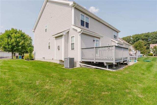 back of property featuring a deck, central air condition unit, and a lawn