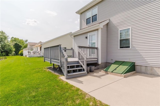 back of house featuring a yard and a deck