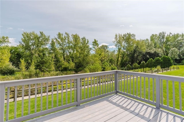 wooden deck with a lawn