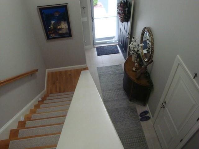 interior space featuring stairs and baseboards