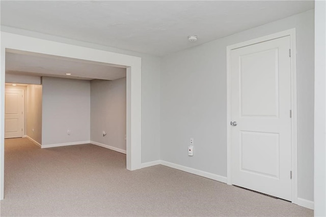 unfurnished room with carpet flooring and baseboards