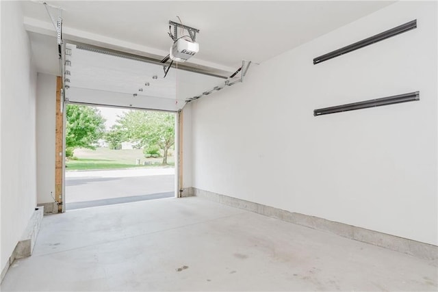 garage with a garage door opener and baseboards