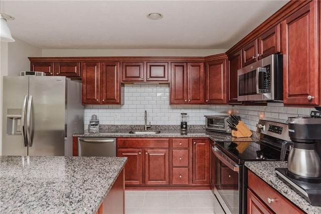 kitchen featuring a sink, appliances with stainless steel finishes, and dark brown cabinets