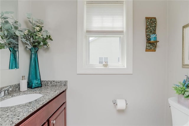 bathroom featuring vanity and toilet