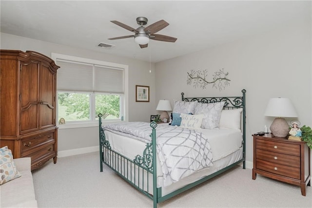 bedroom featuring light carpet, visible vents, ceiling fan, and baseboards