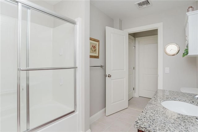 full bath featuring tile patterned flooring, visible vents, vanity, and a shower with shower door