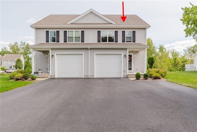 view of front of property with aphalt driveway and an attached garage