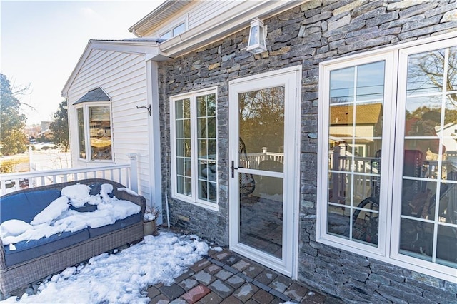 doorway to property featuring stone siding