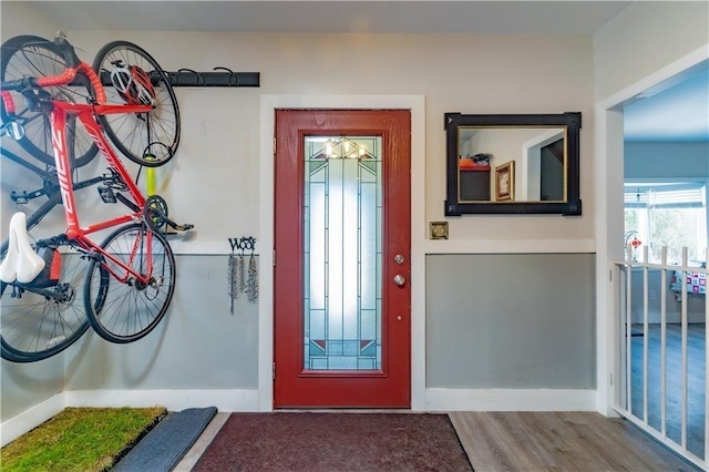 entrance foyer featuring baseboards and wood finished floors