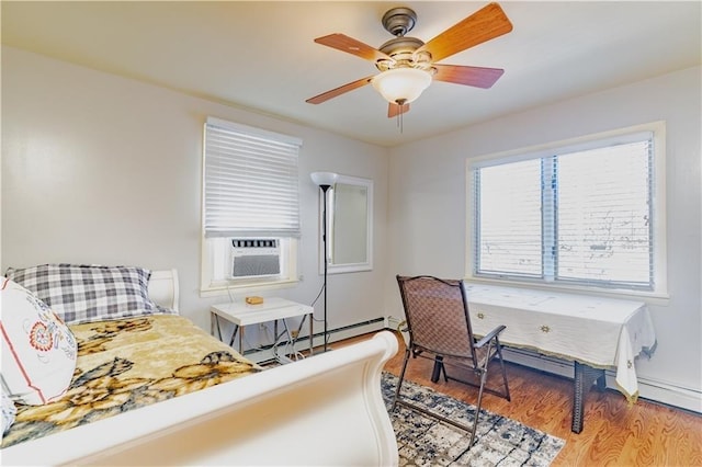 bedroom featuring a baseboard radiator, cooling unit, wood finished floors, and a ceiling fan