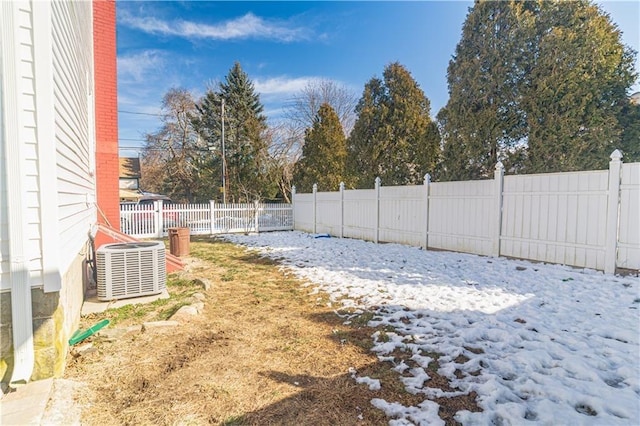 view of yard with central air condition unit and fence