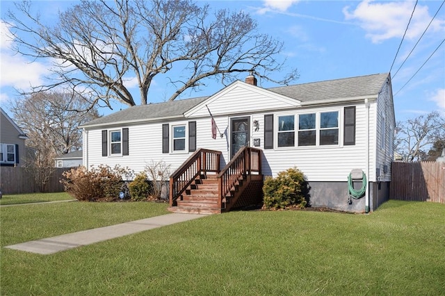 view of front of property featuring a front yard, fence, and a chimney