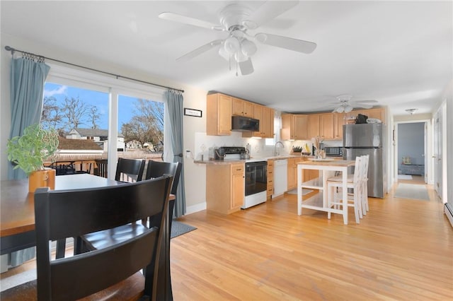 kitchen featuring light brown cabinets, freestanding refrigerator, electric stove, black microwave, and dishwasher