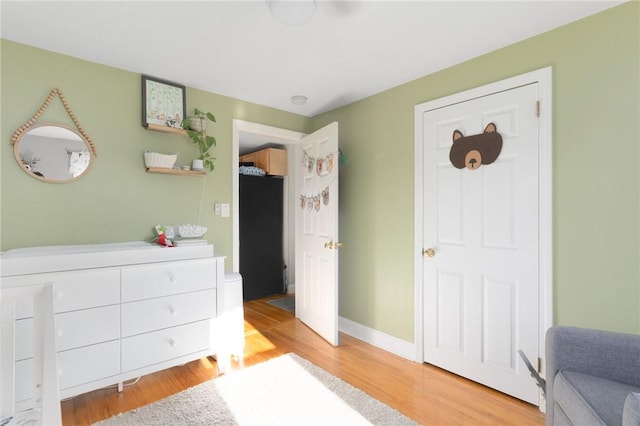 bedroom with baseboards and light wood finished floors