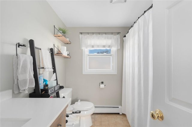 full bathroom featuring tile patterned floors, baseboard heating, toilet, and vanity