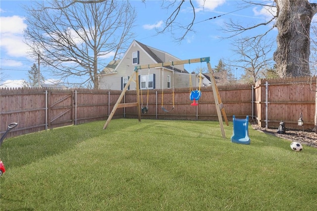 view of yard with a playground and a fenced backyard