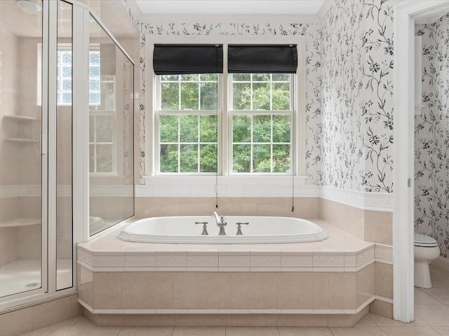 bathroom with a bath, wallpapered walls, a shower stall, tile patterned floors, and toilet