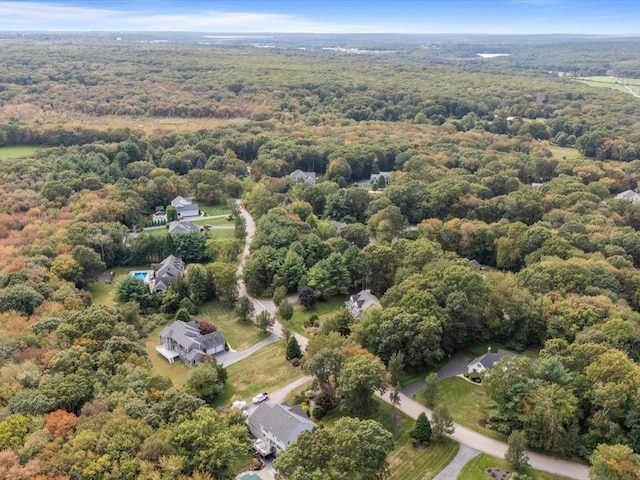 birds eye view of property featuring a wooded view