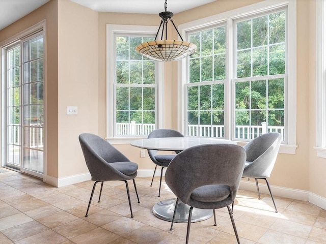 dining area featuring light tile patterned flooring and baseboards