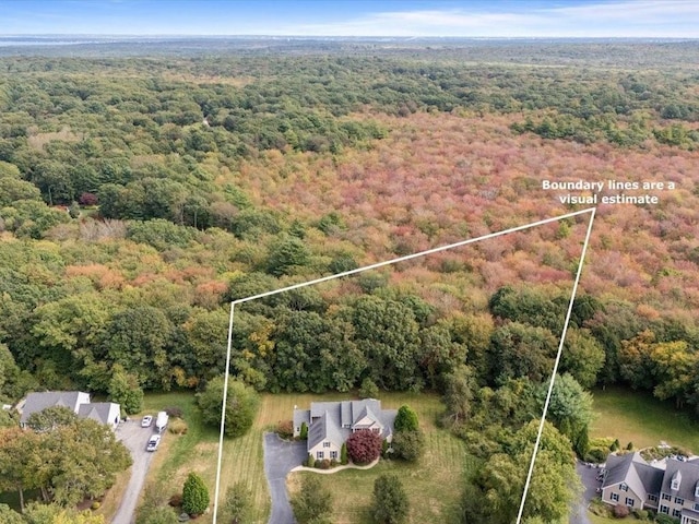 birds eye view of property featuring a wooded view