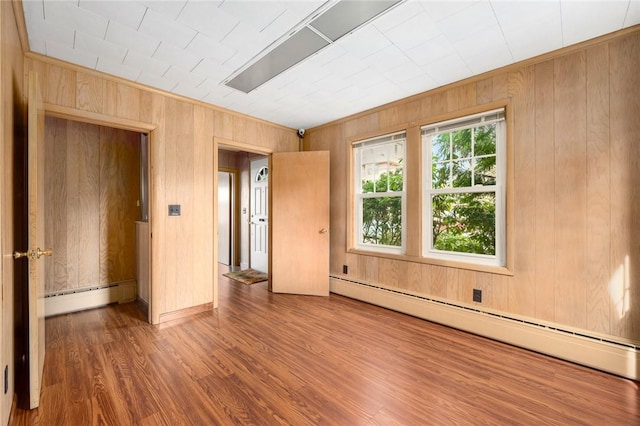 277 Waterman St, Providence, RI 02906 - spare room featuring wood walls, a baseboard heating unit, and wood finished floors