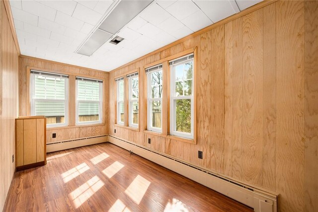 277 Waterman St, Providence, RI 02906 - unfurnished sunroom featuring wood finished floors, wooden walls, and a baseboard heating unit