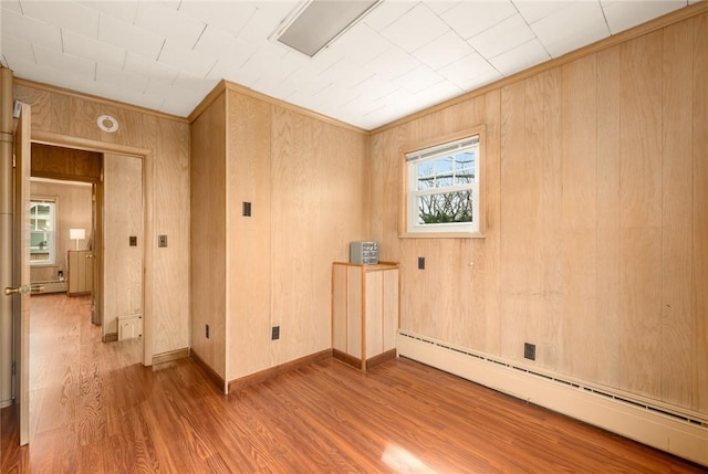 277 Waterman St, Providence, RI 02906 - empty room featuring wood walls, a baseboard radiator, and wood finished floors