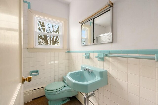 277 Waterman St, Providence, RI 02906 - half bathroom featuring toilet, tile walls, a wainscoted wall, and baseboard heating