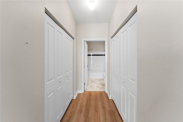 hallway featuring light wood-style flooring