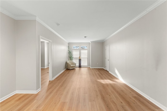 unfurnished room featuring light wood-style flooring, baseboards, visible vents, and ornamental molding