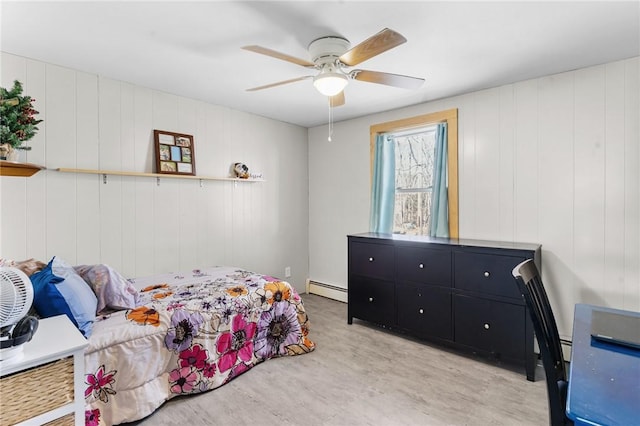 bedroom with light wood-type flooring, a baseboard heating unit, and ceiling fan