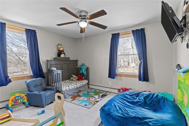 bedroom with baseboard heating and a ceiling fan