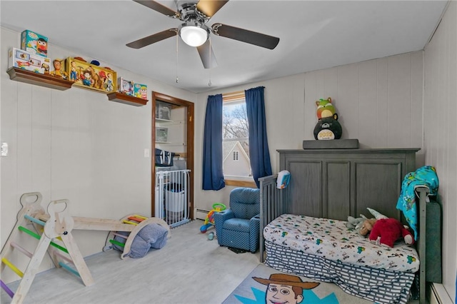 bedroom featuring a baseboard heating unit and a ceiling fan