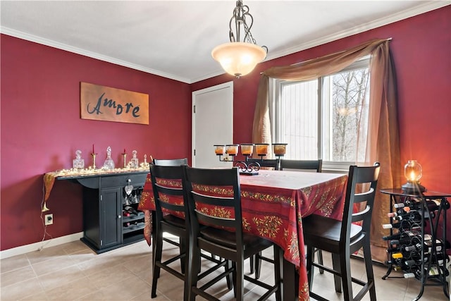 dining room with light tile patterned floors, crown molding, and baseboards