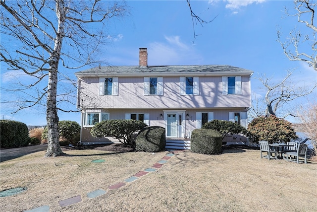 view of front of home featuring a chimney