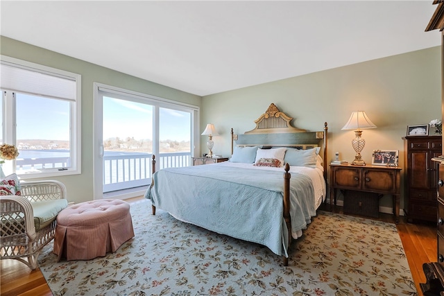 bedroom featuring wood finished floors and access to outside