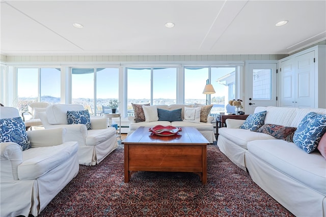 living room featuring a wealth of natural light, recessed lighting, and a baseboard heating unit