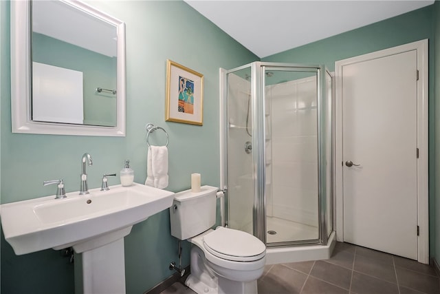 full bath featuring tile patterned floors, toilet, a shower stall, and a sink