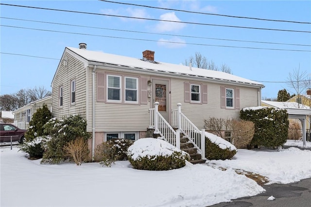 view of front of house featuring a chimney