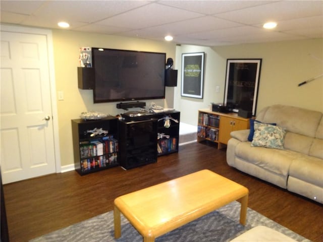 living area with recessed lighting, wood finished floors, and a drop ceiling