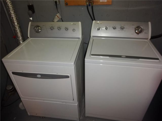 clothes washing area featuring laundry area and separate washer and dryer