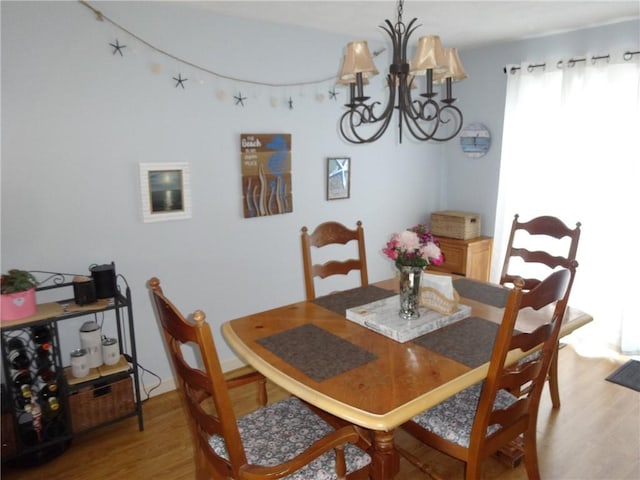 dining room with an inviting chandelier and light wood-style floors