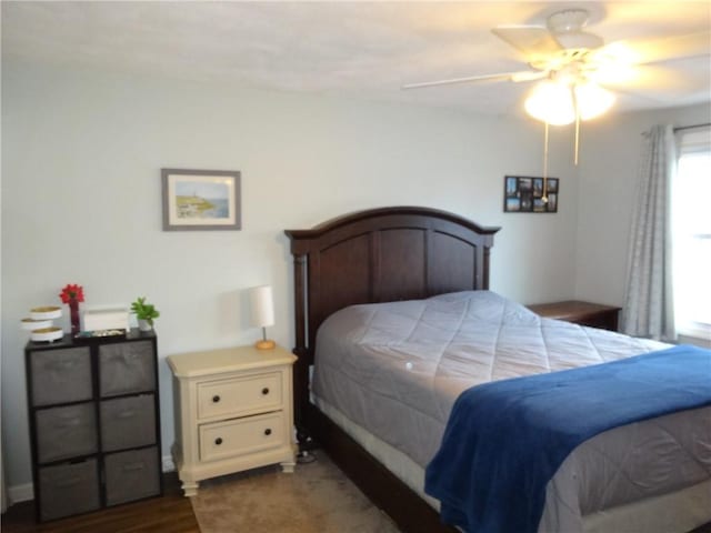 bedroom featuring dark wood finished floors and a ceiling fan