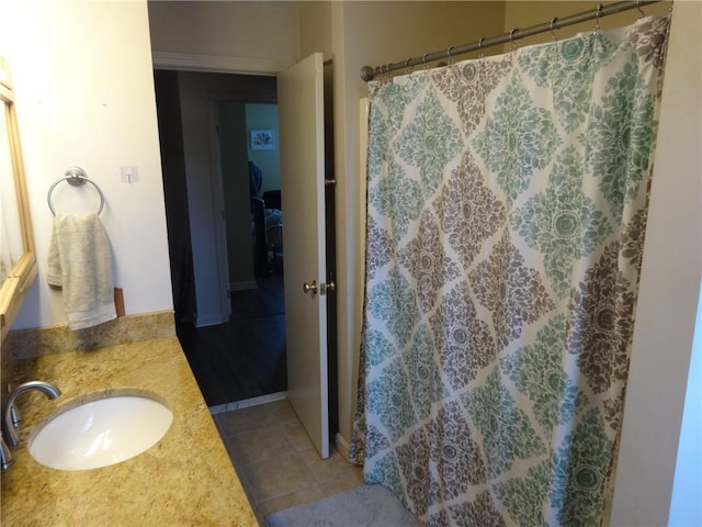 full bathroom with tile patterned flooring, curtained shower, and a sink