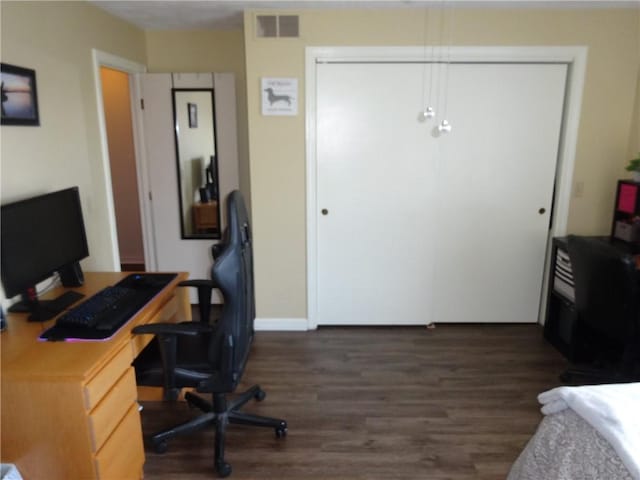 office featuring visible vents, baseboards, and wood finished floors