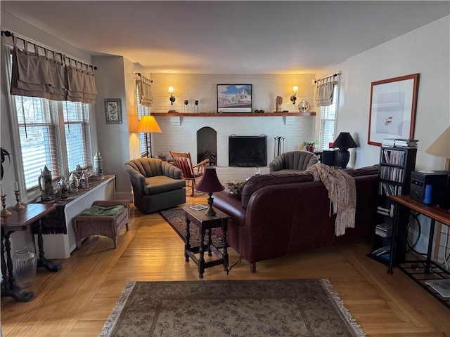 living area with a fireplace and light wood finished floors