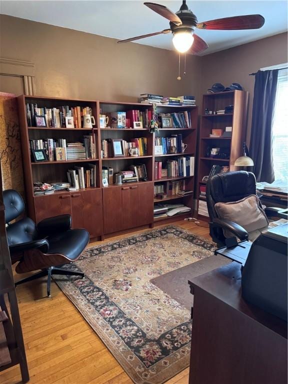 office space with a ceiling fan and light wood-type flooring