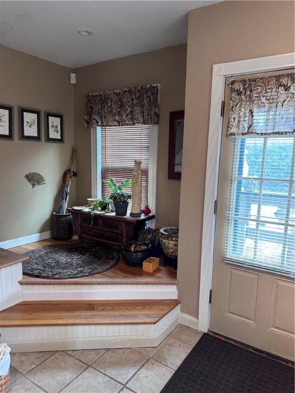 interior space featuring light tile patterned floors and baseboards