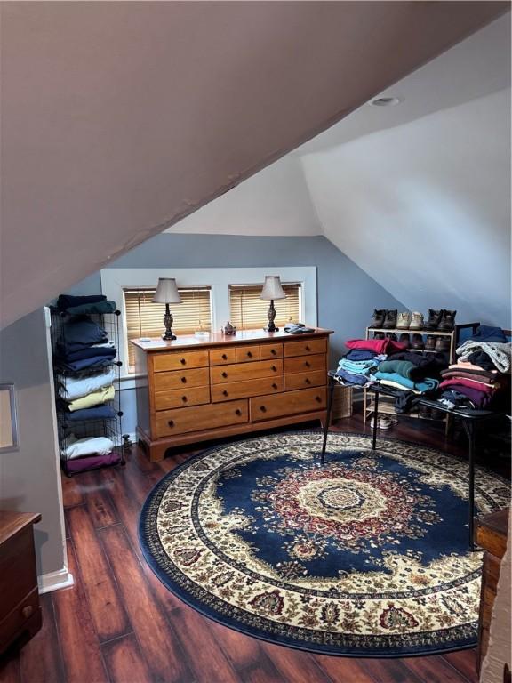 bedroom with lofted ceiling and dark wood-type flooring