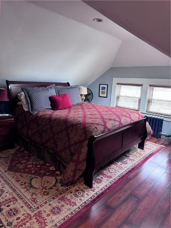 bedroom featuring lofted ceiling and hardwood / wood-style floors